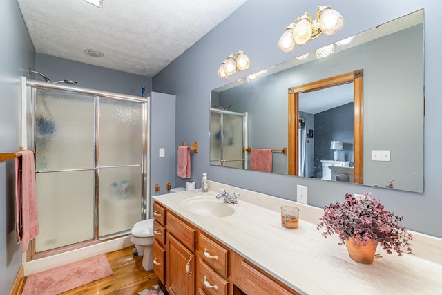 1019 Fisher Rd, Foster, KY 41043 - full bathroom with wood finished floors, a stall shower, vanity, a textured ceiling, and toilet
