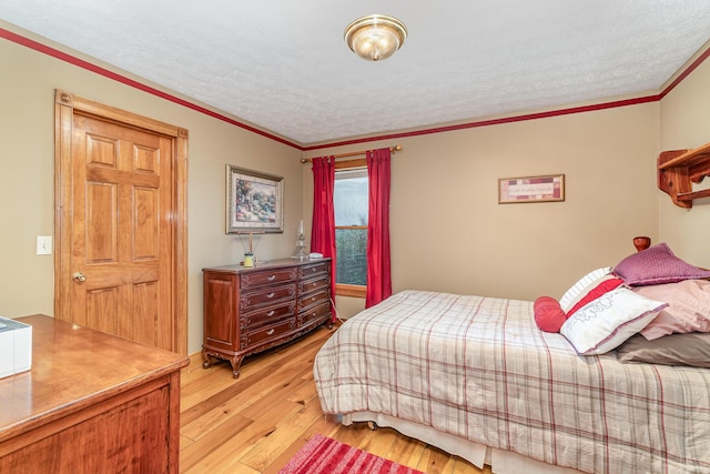 1019 Fisher Rd, Foster, KY 41043 - bedroom with light wood-type flooring, a textured ceiling, and crown molding