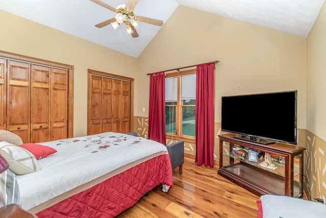 1019 Fisher Rd, Foster, KY 41043 - bedroom featuring light wood finished floors, high vaulted ceiling, two closets, and ceiling fan