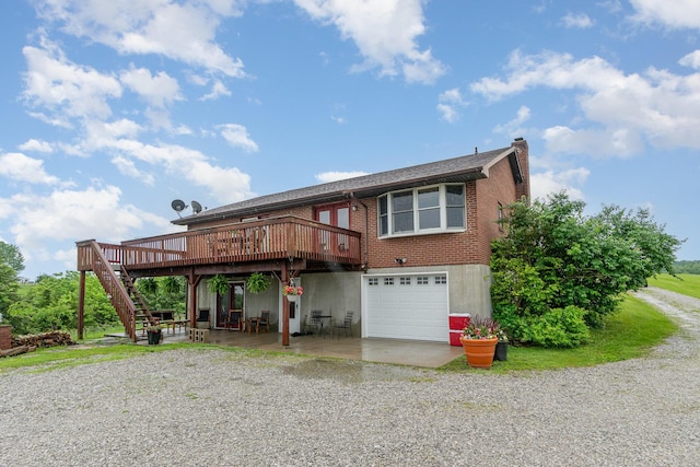 1019 Fisher Rd, Foster, KY 41043 - view of front of house featuring a wooden deck, gravel driveway, a chimney, stairs, and an attached garage