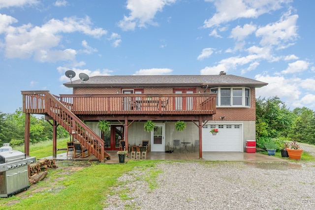 1019 Fisher Rd, Foster, KY 41043 - back of property with driveway, a deck, a garage, brick siding, and a patio area