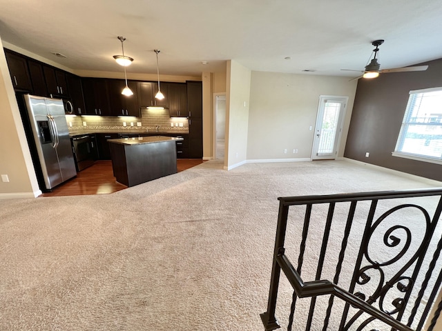 1859 Riverpointe Ct Unit 11, Dayton, KY 41074 - kitchen with appliances with stainless steel finishes, light colored carpet, tasteful backsplash, open floor plan, and a center island