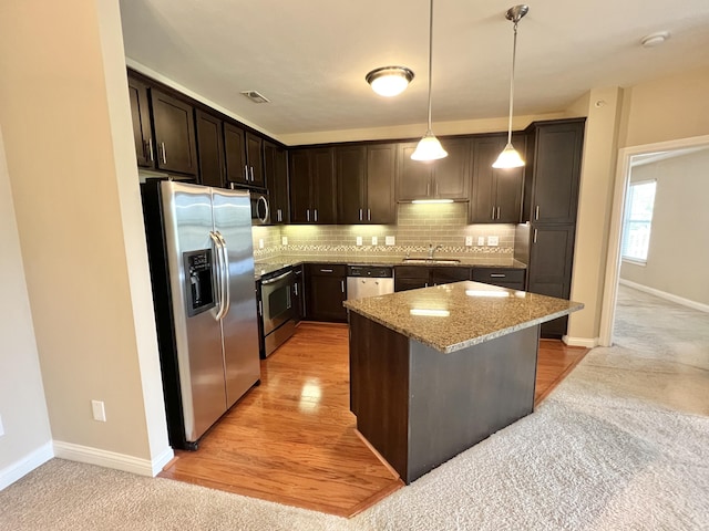 1859 Riverpointe Ct Unit 11, Dayton, KY 41074 - kitchen with stainless steel appliances, light stone countertops, dark brown cabinetry, a sink, and decorative backsplash