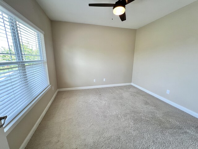 1859 Riverpointe Ct Unit 11, Dayton, KY 41074 - carpeted spare room featuring plenty of natural light, a ceiling fan, and baseboards