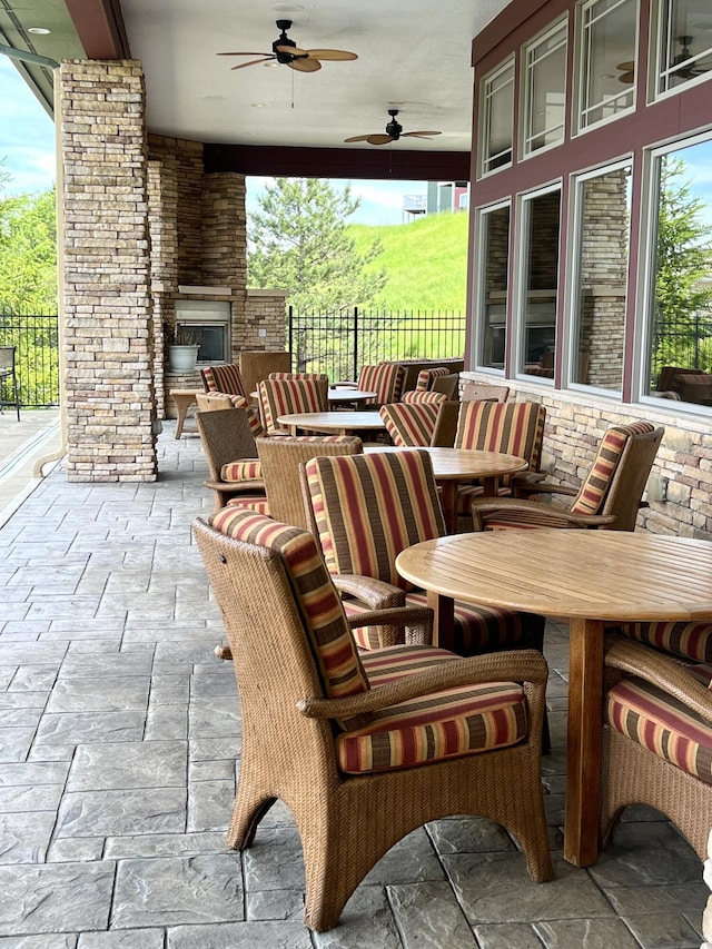 1859 Riverpointe Ct Unit 11, Dayton, KY 41074 - view of patio / terrace featuring exterior fireplace, outdoor dining area, and ceiling fan