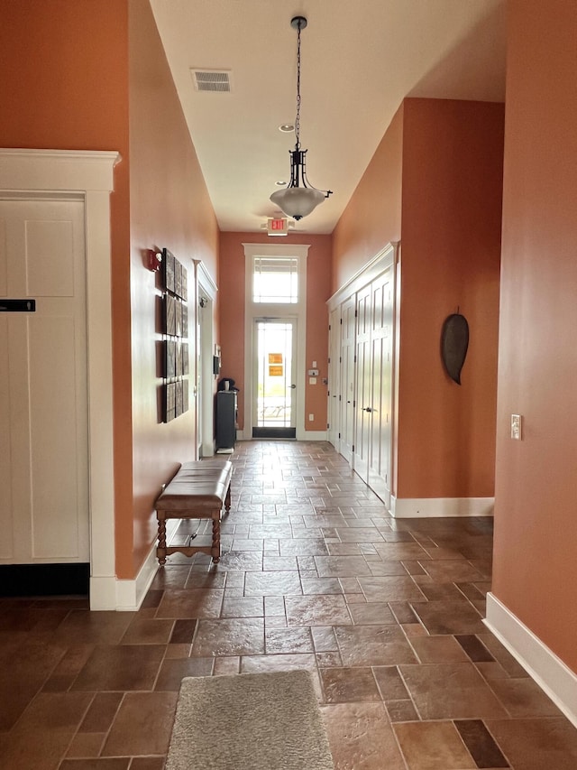 1859 Riverpointe Ct Unit 11, Dayton, KY 41074 - entryway featuring baseboards, a towering ceiling, and stone tile floors