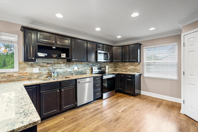 21 Laurel Ridge Dr, Alexandria, KY 41001 - kitchen featuring appliances with stainless steel finishes, a sink, ornamental molding, light stone counters, and healthy amount of natural light