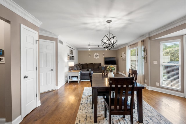 21 Laurel Ridge Dr, Alexandria, KY 41001 - dining area with crown molding, a chandelier, wood finished floors, and baseboards