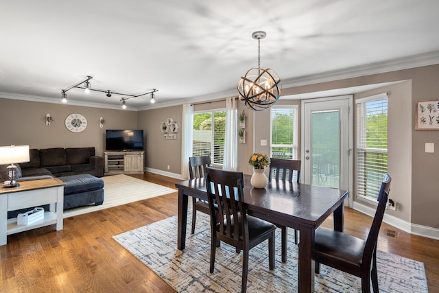 21 Laurel Ridge Dr, Alexandria, KY 41001 - dining room featuring crown molding, a chandelier, rail lighting, plenty of natural light, and wood finished floors