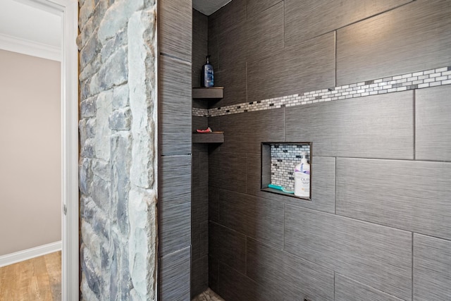 21 Laurel Ridge Dr, Alexandria, KY 41001 - bathroom with crown molding, baseboards, wood finished floors, and a tile shower