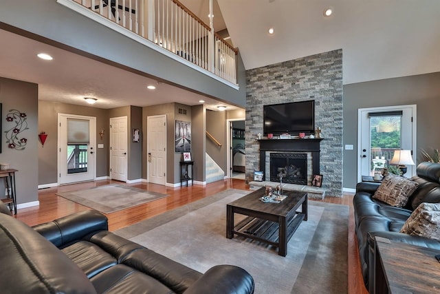445 Elk Lake Resort Rd Unit 882, Owenton, KY 40359 - living area with wood finished floors, stairway, baseboards, a stone fireplace, and high vaulted ceiling