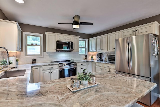445 Elk Lake Resort Rd Unit 882, Owenton, KY 40359 - kitchen featuring stainless steel appliances, a sink, light stone countertops, a ceiling fan, and tasteful backsplash
