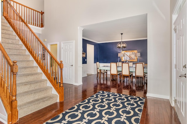 8394 Saint Louis Blvd, Union, KY 41091 - entrance foyer with hardwood / wood-style floors, baseboards, stairway, crown molding, and a chandelier