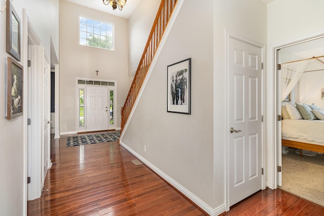 8394 Saint Louis Blvd, Union, KY 41091 - foyer entrance with dark wood-style flooring, baseboards, stairs, a chandelier, and a towering ceiling