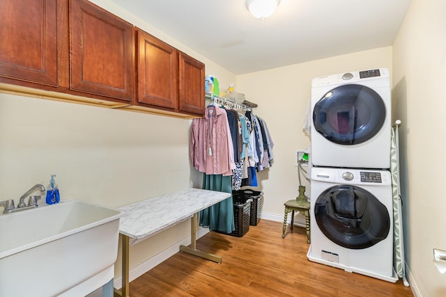 8394 Saint Louis Blvd, Union, KY 41091 - laundry room with stacked washer / dryer, cabinet space, light wood-style flooring, and baseboards