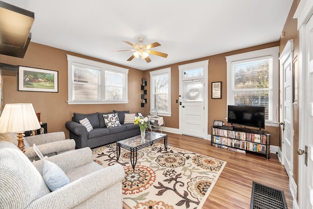 615 Highland Pike, Covington, KY 41014 - living room with plenty of natural light, light wood-type flooring, a ceiling fan, and baseboards