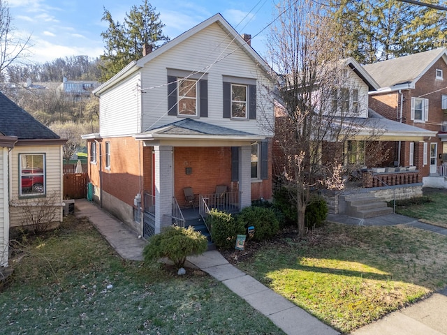615 Highland Pike, Covington, KY 41014 - traditional-style house featuring brick siding, covered porch, a chimney, and cooling unit