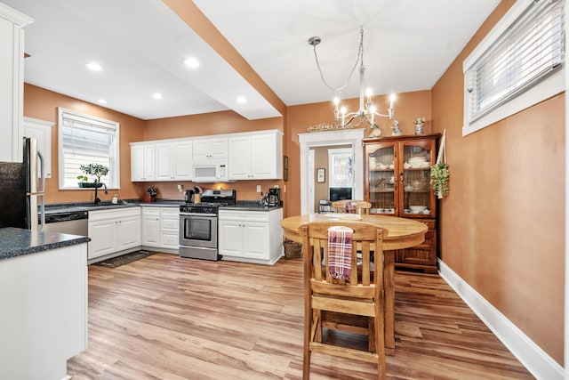 615 Highland Pike, Covington, KY 41014 - kitchen with stainless steel appliances, white cabinetry, light wood-style floors, dark countertops, and recessed lighting