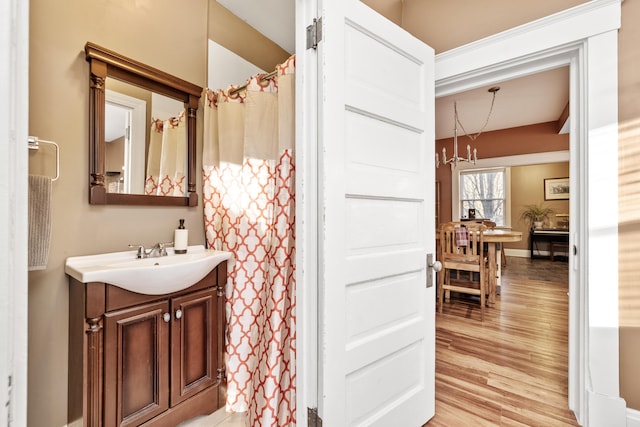 615 Highland Pike, Covington, KY 41014 - bathroom featuring wood finished floors, vanity, baseboards, and a shower with shower curtain