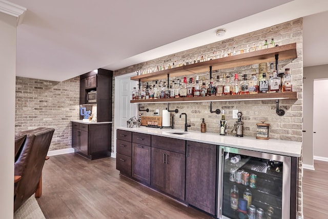 721 Dudley Rd, Edgewood, KY 41017 - indoor wet bar with beverage cooler, wood finished floors, baseboards, and brick wall