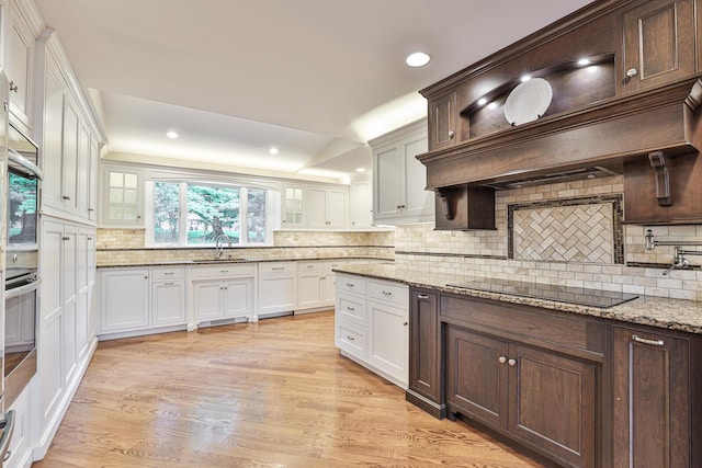 721 Dudley Rd, Edgewood, KY 41017 - kitchen with black electric stovetop, glass insert cabinets, tasteful backsplash, and recessed lighting