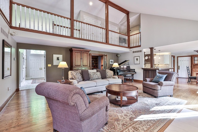 721 Dudley Rd, Edgewood, KY 41017 - living room featuring high vaulted ceiling, light wood finished floors, baseboards, ceiling fan, and beamed ceiling