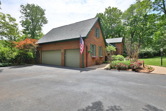 721 Dudley Rd, Edgewood, KY 41017 - view of property exterior featuring asphalt driveway, brick siding, a shingled roof, and an attached garage
