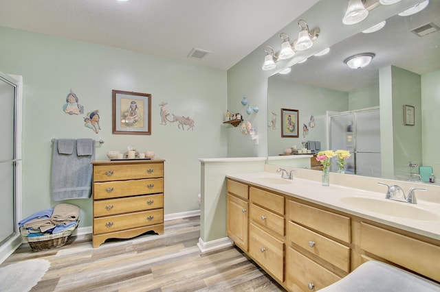 5913 Boulder Vw, Cold Spring, KY 41076 - bathroom with a shower stall, wood finished floors, double vanity, baseboards, and toilet