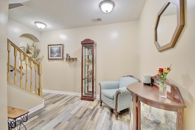 5913 Boulder Vw, Cold Spring, KY 41076 - living area with wood finished floors, stairs, baseboards, a textured ceiling, and arched walkways