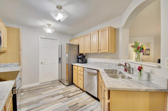 5913 Boulder Vw, Cold Spring, KY 41076 - kitchen with appliances with stainless steel finishes, light brown cabinets, a sink, light wood-style floors, and arched walkways