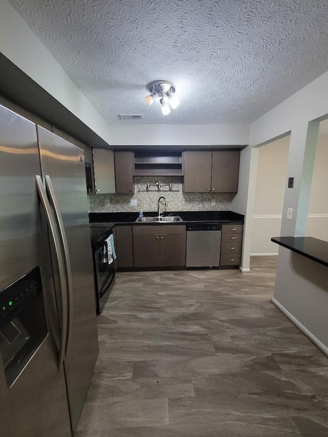 122 Whitney Ct, Crestview Hills, KY 41017 - kitchen featuring stainless steel appliances, dark countertops, open shelves, tasteful backsplash, and a textured ceiling