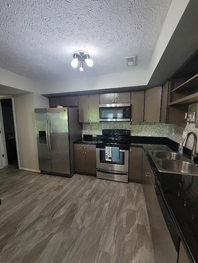 122 Whitney Ct, Crestview Hills, KY 41017 - kitchen with stainless steel appliances, a textured ceiling, tasteful backsplash, dark wood finished floors, and open shelves