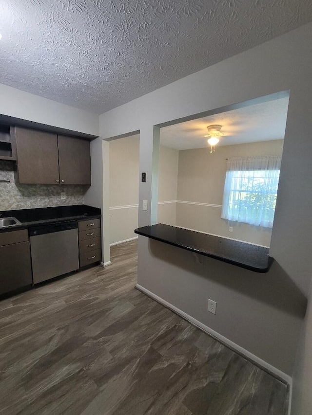 122 Whitney Ct, Crestview Hills, KY 41017 - kitchen with stainless steel dishwasher, dark countertops, a textured ceiling, dark wood finished floors, and a ceiling fan