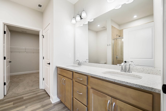 8492 Concerto Ct, Union, KY 41091 - bathroom with a shower stall, wood finished floors, double vanity, a spacious closet, and toilet