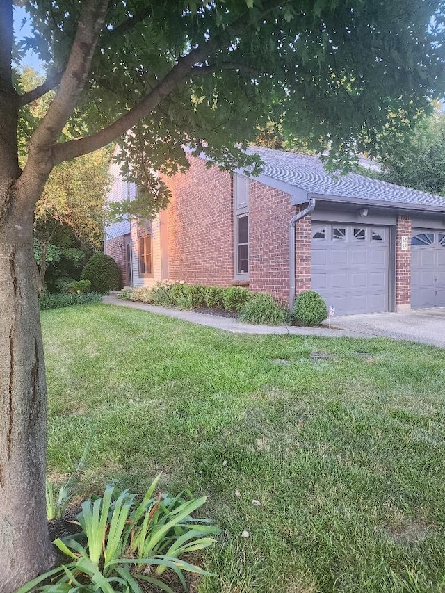 218 Shaker Heights Ln, Crestview Hills, KY 41017 - view of side of home with brick siding, a garage, a yard, and asphalt driveway