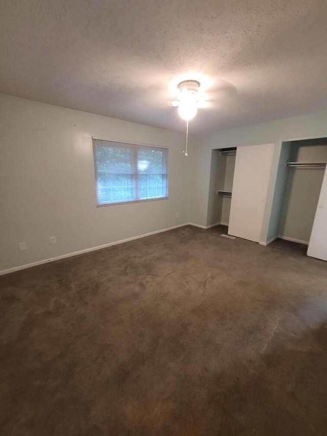 218 Shaker Heights Ln, Crestview Hills, KY 41017 - unfurnished bedroom featuring dark colored carpet, two closets, and a textured ceiling