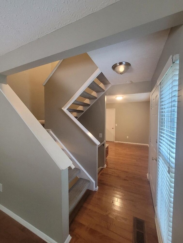 218 Shaker Heights Ln, Crestview Hills, KY 41017 - hall featuring wood finished floors, stairway, and a textured ceiling