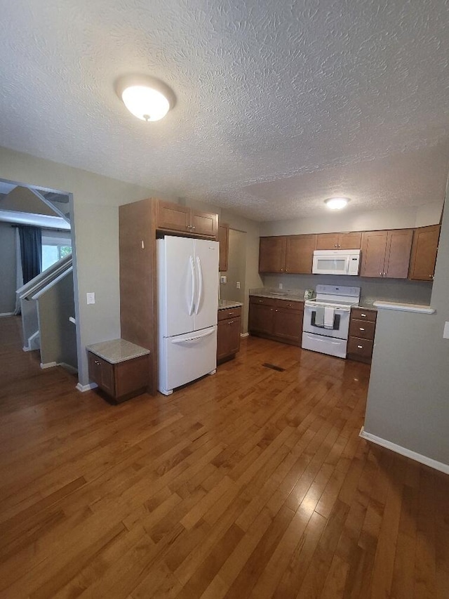 218 Shaker Heights Ln, Crestview Hills, KY 41017 - kitchen featuring white appliances, a textured ceiling, dark wood-type flooring, and light countertops