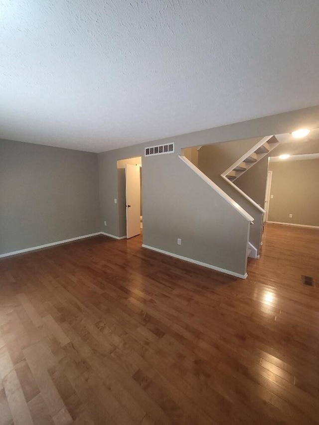 218 Shaker Heights Ln, Crestview Hills, KY 41017 - unfurnished living room featuring wood finished floors, stairway, and a textured ceiling