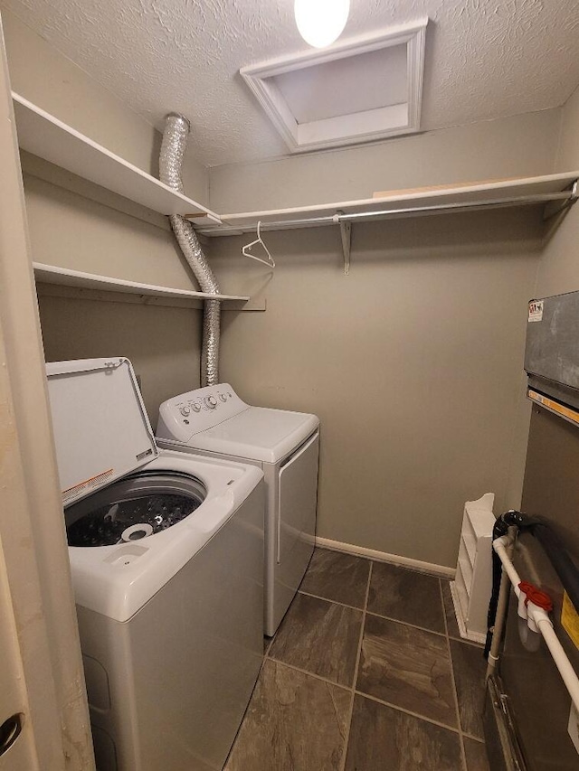 152 Steelway Farm Ct, Crestview Hills, KY 41017 - washroom featuring washer and clothes dryer, attic access, a textured ceiling, and dark tile patterned floors