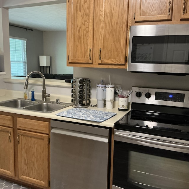 351 Deepwoods Dr, Newport, KY 41076 - kitchen featuring appliances with stainless steel finishes, a sink, and light countertops