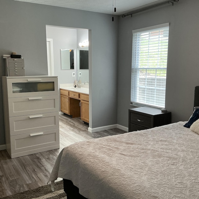 351 Deepwoods Dr, Newport, KY 41076 - bedroom featuring light wood-style floors, baseboards, ensuite bathroom, and a sink