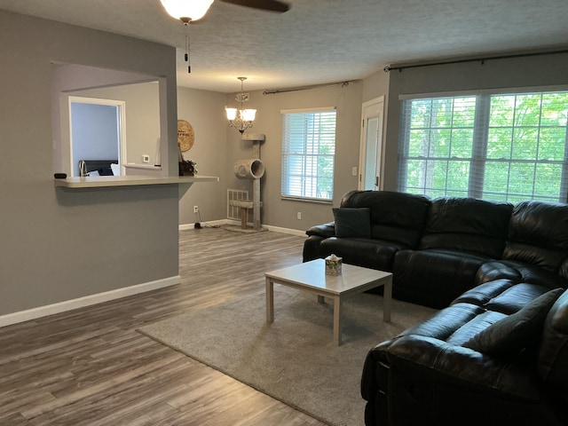 351 Deepwoods Dr, Newport, KY 41076 - living room with a chandelier, wood finished floors, baseboards, ceiling fan, and a textured ceiling