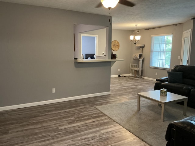 351 Deepwoods Dr, Newport, KY 41076 - living area with wood finished floors, baseboards, ceiling fan, a chandelier, and a textured ceiling
