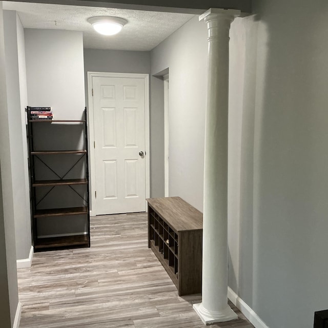 351 Deepwoods Dr, Newport, KY 41076 - mudroom featuring decorative columns, light wood finished floors, a textured ceiling, and baseboards