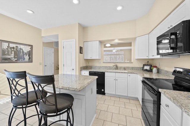 1622 Castle Hill Ln, Fort Wright, KY 41011 - kitchen with black appliances, a sink, a kitchen bar, white cabinets, and recessed lighting