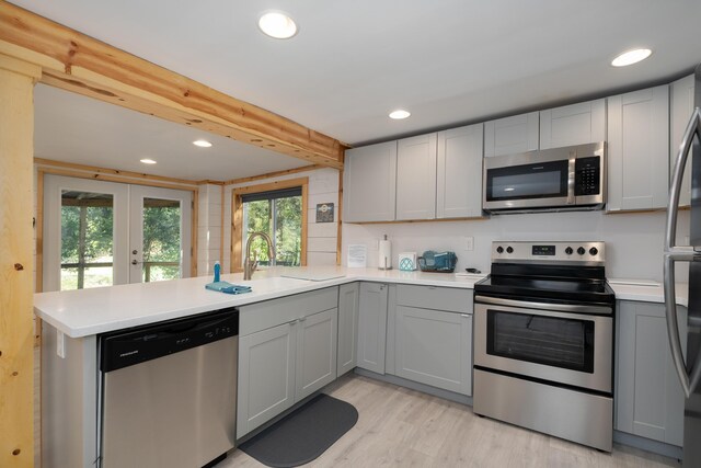 310 Greene Rd, Williamstown, KY 41097 - kitchen featuring stainless steel appliances, a peninsula, gray cabinets, a sink, and light countertops