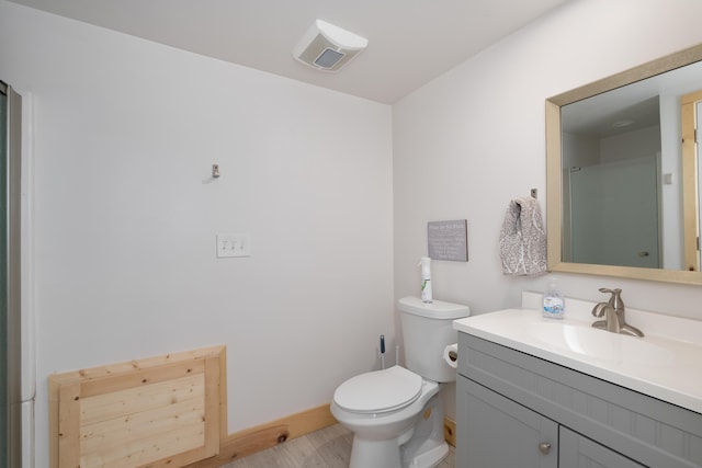 310 Greene Rd, Williamstown, KY 41097 - bathroom with vanity, toilet, baseboards, and wood finished floors