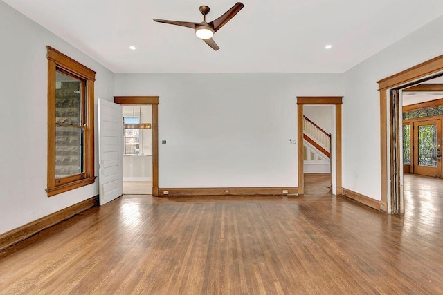 274 Ward Ave, Bellevue, KY 41073 - unfurnished room featuring wood finished floors, baseboards, a ceiling fan, and stairway