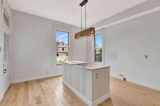 274 Ward Ave, Bellevue, KY 41073 - kitchen with light wood-type flooring, pendant lighting, a kitchen island, and baseboards
